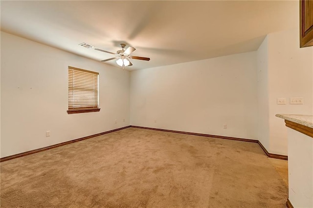 carpeted spare room with ceiling fan