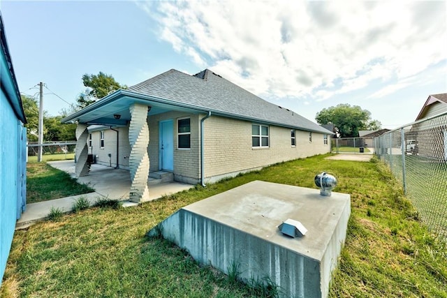 back of house featuring a patio area and a yard