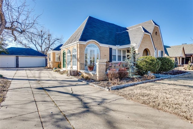 view of front of property with a garage and an outdoor structure