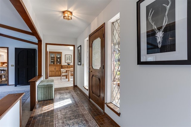 entryway with beamed ceiling