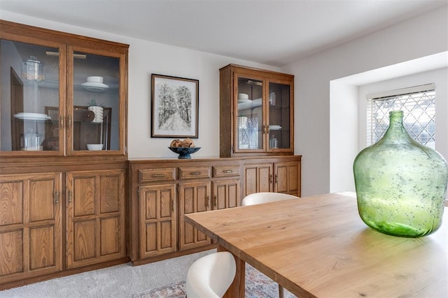 dining space featuring light colored carpet