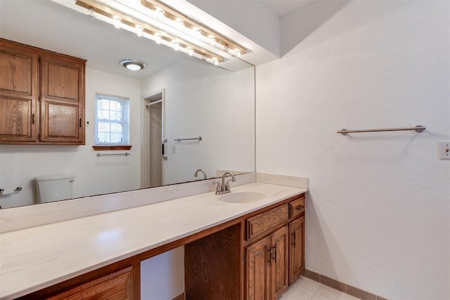 bathroom featuring tile patterned floors, vanity, and toilet