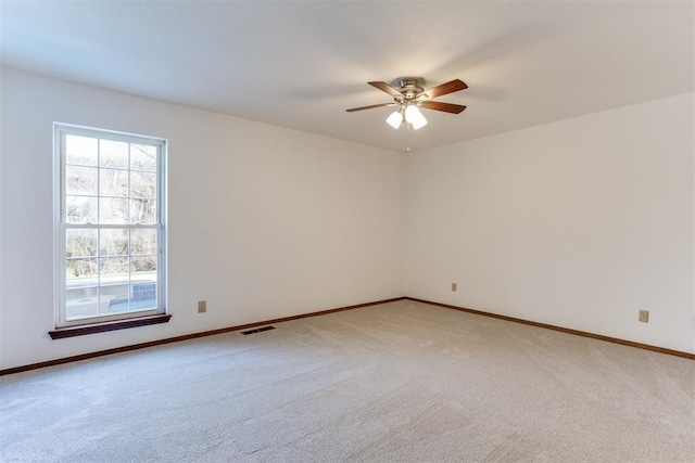 empty room featuring carpet and ceiling fan