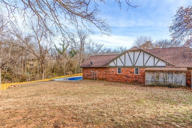 view of property exterior with a yard and an empty pool