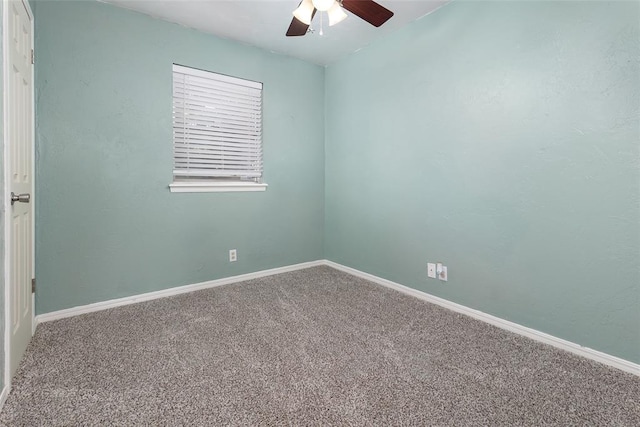 carpeted spare room featuring ceiling fan