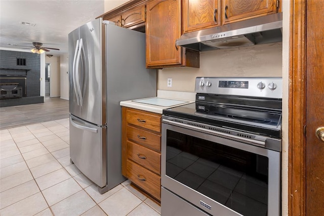 kitchen with light tile patterned flooring, ceiling fan, and appliances with stainless steel finishes