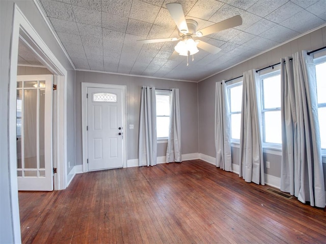 entryway featuring hardwood / wood-style flooring, ceiling fan, and ornamental molding