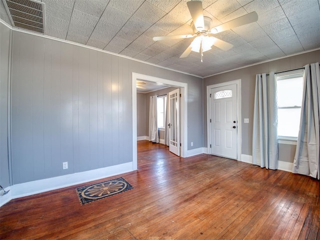 entryway with crown molding, wood-type flooring, and ceiling fan