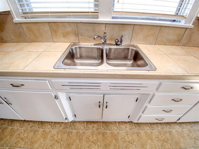 kitchen featuring sink and white cabinetry