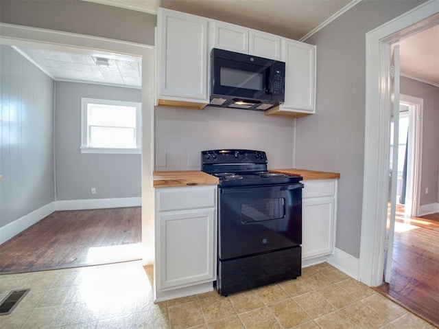 kitchen featuring black appliances, wood counters, white cabinetry, and ornamental molding