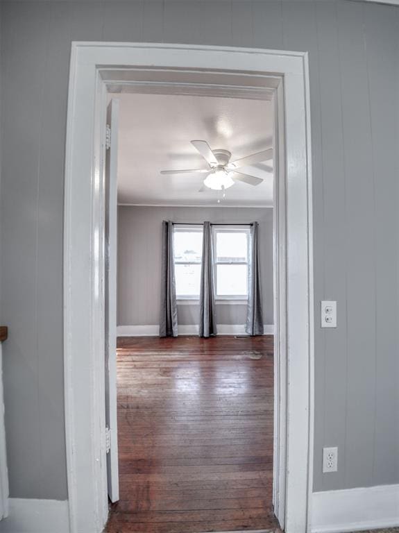 hall with dark hardwood / wood-style flooring and ornamental molding