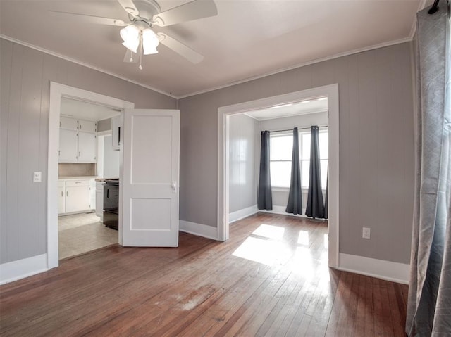 unfurnished room with hardwood / wood-style flooring, crown molding, and ceiling fan