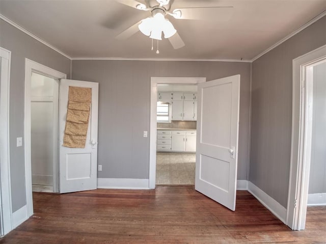 unfurnished bedroom with ceiling fan, wood-type flooring, and crown molding