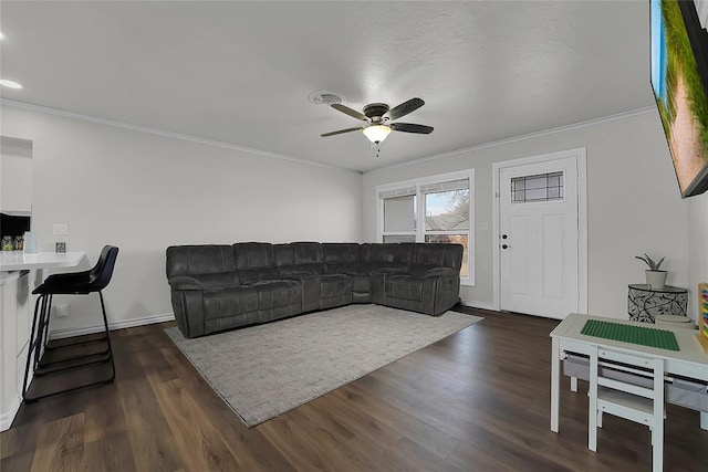 living room with ornamental molding, ceiling fan, and dark hardwood / wood-style flooring