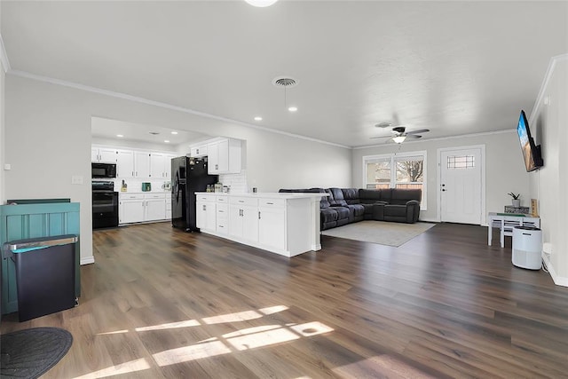 living room with crown molding, ceiling fan, and dark wood-type flooring