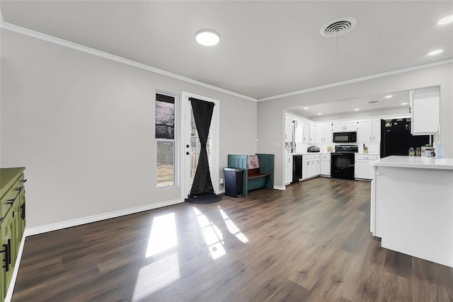 kitchen with crown molding, white cabinets, dark hardwood / wood-style floors, and black appliances