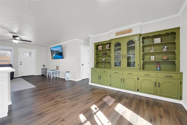 unfurnished dining area with ornamental molding, dark hardwood / wood-style floors, and ceiling fan