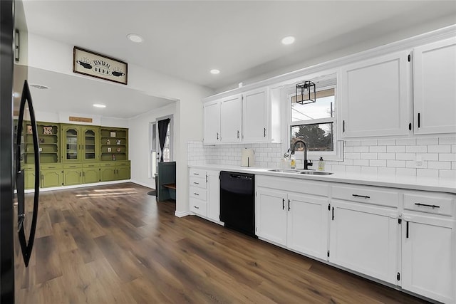 kitchen featuring sink, white cabinets, dark hardwood / wood-style flooring, decorative backsplash, and black appliances