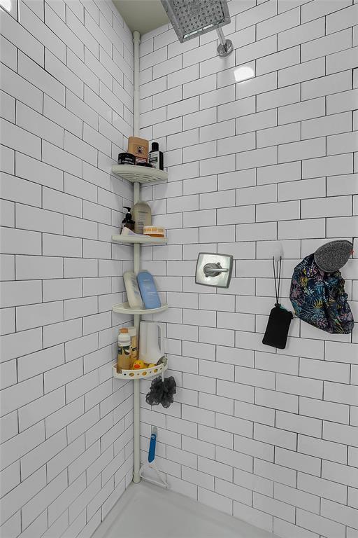 bathroom with tiled shower