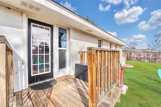 wooden deck featuring a yard