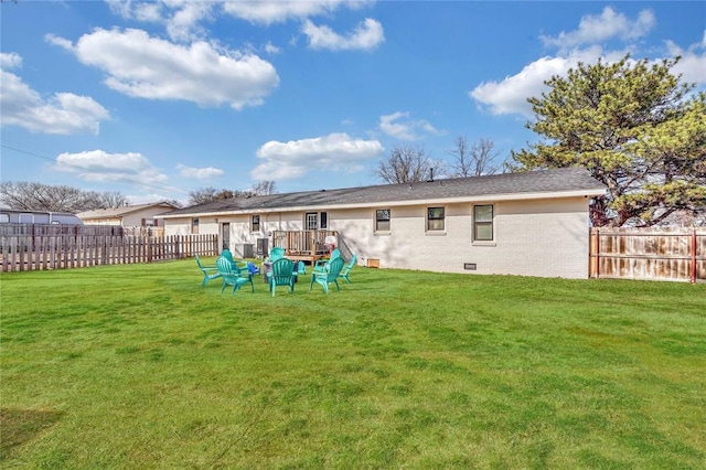 back of property with a wooden deck and a yard