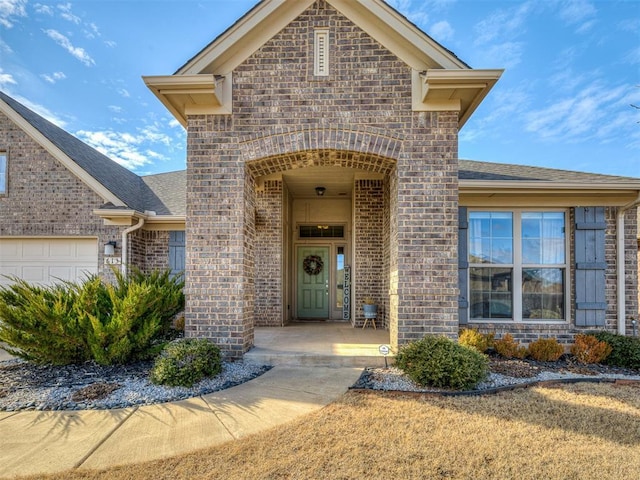 view of exterior entry with a garage