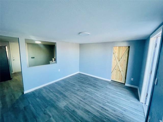 unfurnished room with dark wood-type flooring