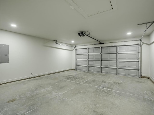 garage featuring a garage door opener, electric panel, and baseboards