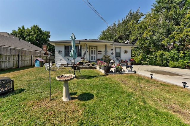 rear view of house with a lawn and a porch