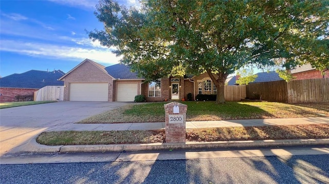 view of front of property featuring a garage and a front yard