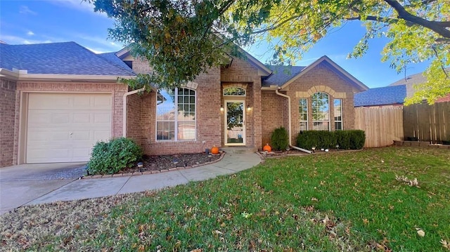 view of front of property featuring a garage and a front lawn