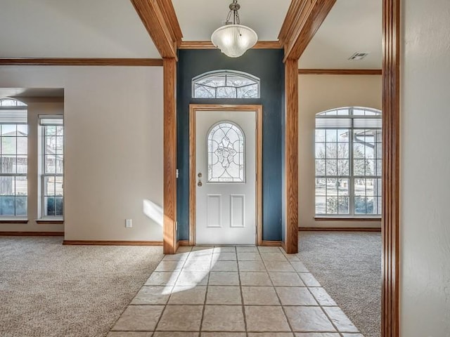 carpeted entryway featuring ornamental molding