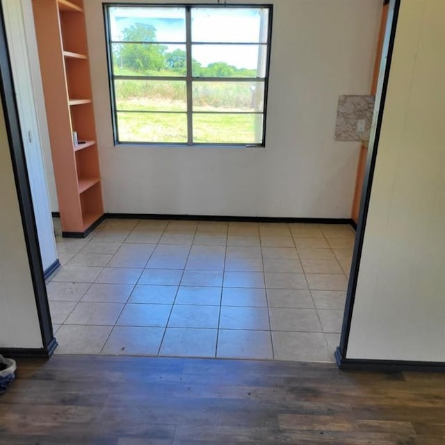 tiled empty room with built in shelves