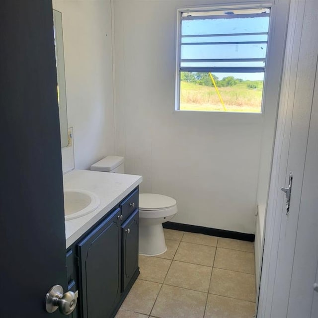 bathroom with tile patterned flooring, vanity, and toilet