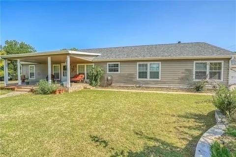 rear view of property with a patio area and a lawn