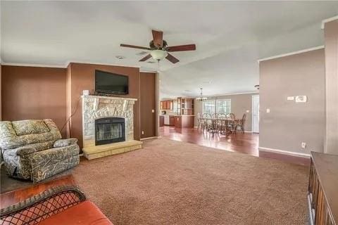 living room featuring ceiling fan, carpet, crown molding, and lofted ceiling