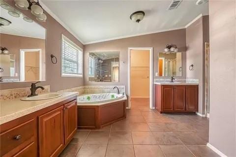 bathroom with a tub, tile patterned flooring, lofted ceiling, and vanity