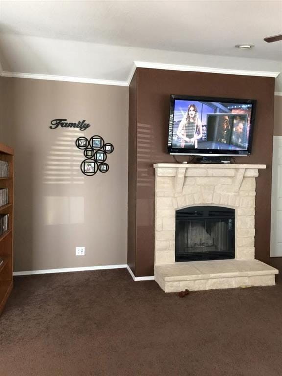 unfurnished living room with a stone fireplace, ornamental molding, and carpet floors