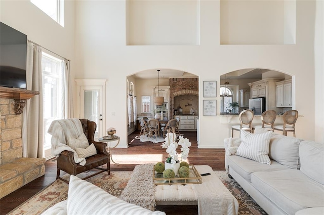 living room with a towering ceiling and hardwood / wood-style floors