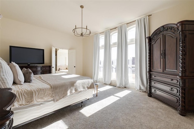 bedroom with light colored carpet, connected bathroom, and a chandelier