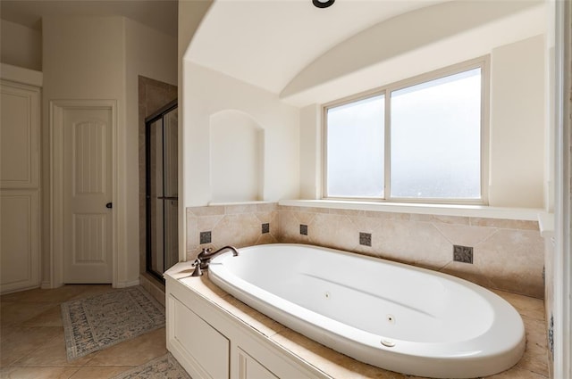 bathroom with vaulted ceiling, plus walk in shower, and tile patterned flooring