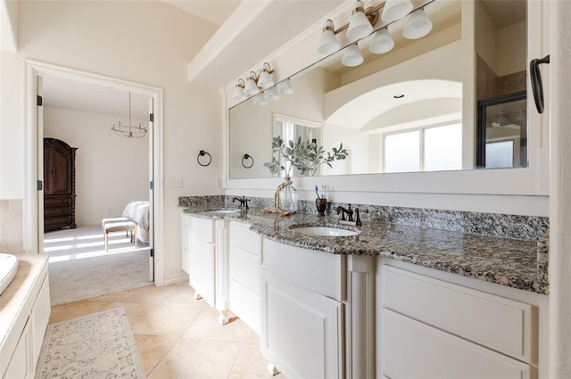 bathroom featuring vanity, a bath, and tile patterned flooring