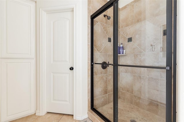 bathroom featuring an enclosed shower and tile patterned flooring