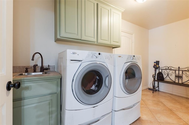 laundry room featuring cabinets, separate washer and dryer, sink, and light tile patterned floors