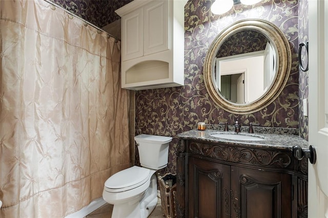 bathroom featuring vanity, tile patterned floors, and toilet