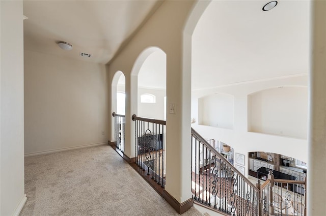 corridor featuring light colored carpet