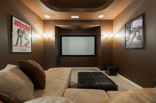 carpeted cinema with a raised ceiling