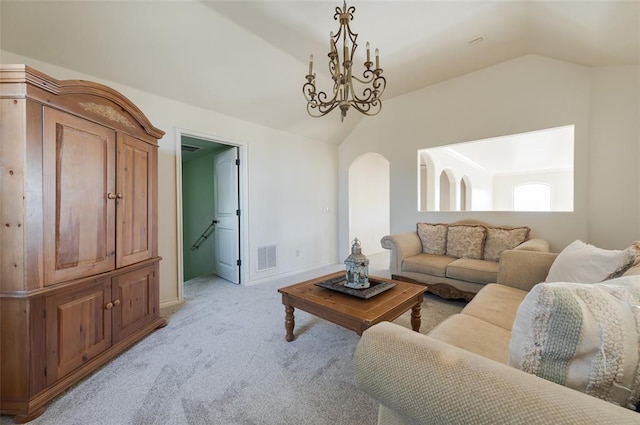 carpeted living room with vaulted ceiling and a notable chandelier