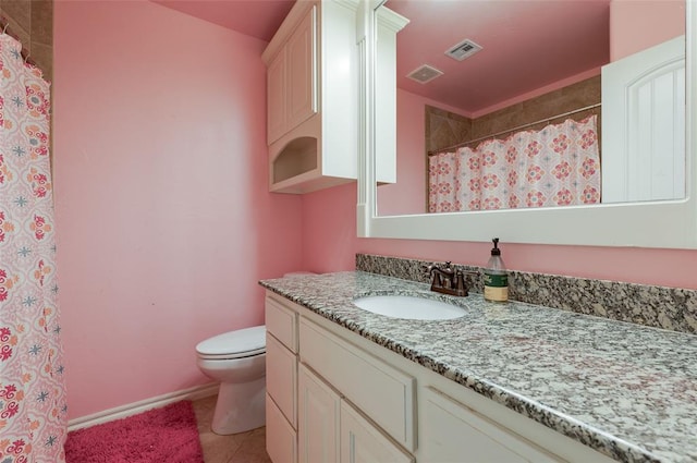 bathroom featuring vanity, tile patterned flooring, and toilet