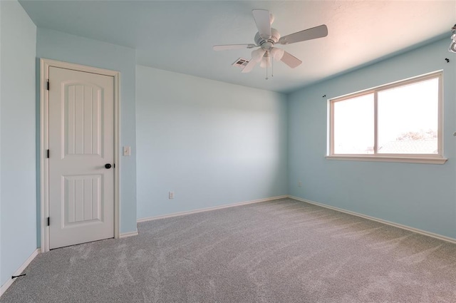 unfurnished room with ceiling fan and light carpet